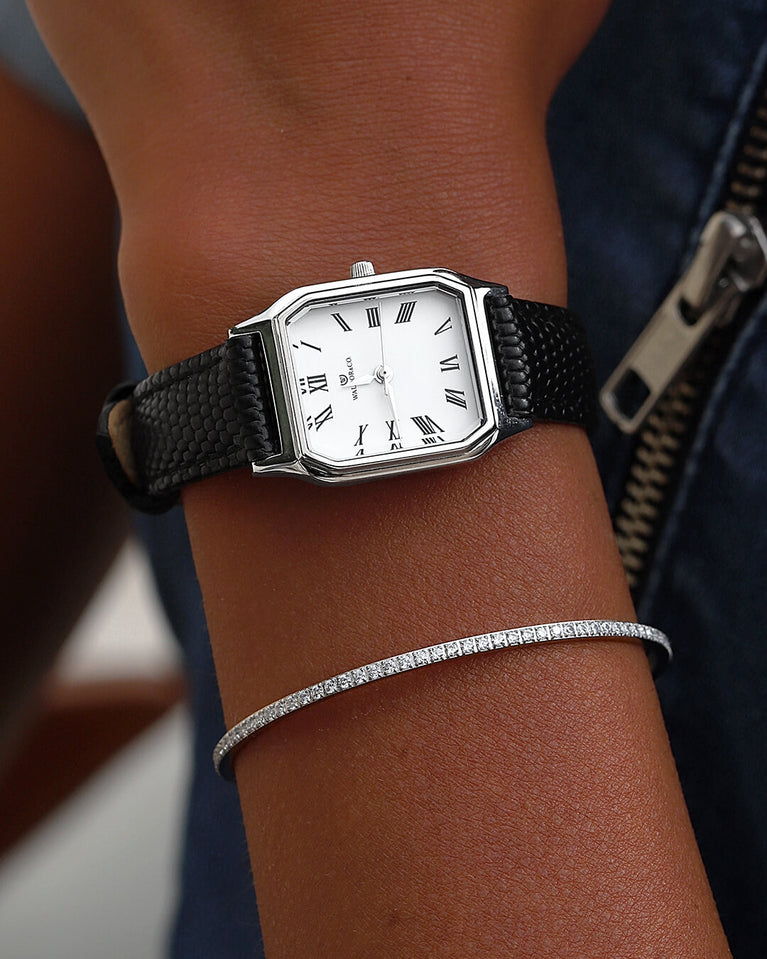 A square womens watch in Rhodium-plated 316L stainless steel with a black genuine leather strap from Waldor & Co. with white Diamond Cut Sapphire Crystal glass dial. Seiko movement. The model is Eternal 22 Varenna.