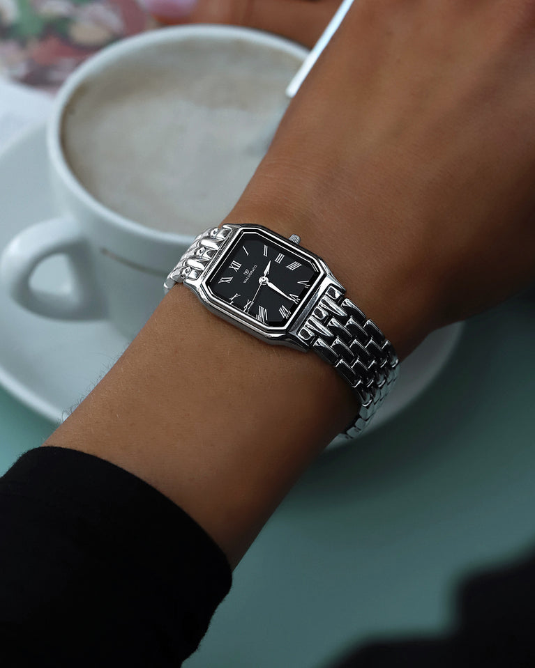 A square womens watch in Rhodium-plated 316L stainless steel from Waldor & Co. with black Diamond Cut Sapphire Crystal glass dial. Seiko movement. The model is Eternal 22 Bellagio.