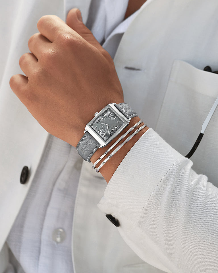 A square mens watch in Rhodium-plated 316L stainless steel from Waldor & Co. with grey guilloche dial. Miyota movement. Leather strap. The model is Conceptual 37 Cap Ferrat.