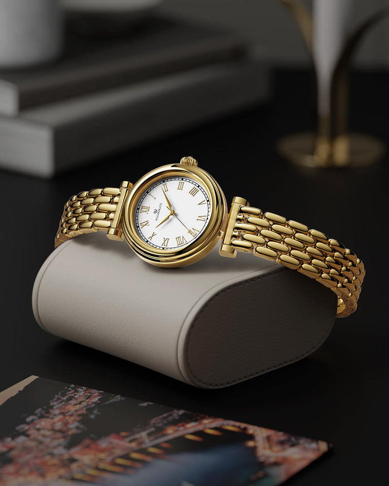 A round womens watch in 22k gold plated 316L stainless steel from Waldor & Co. with white Sapphire Crystal glass dial. Seiko movement. The model is Venia 24 Villefranche.