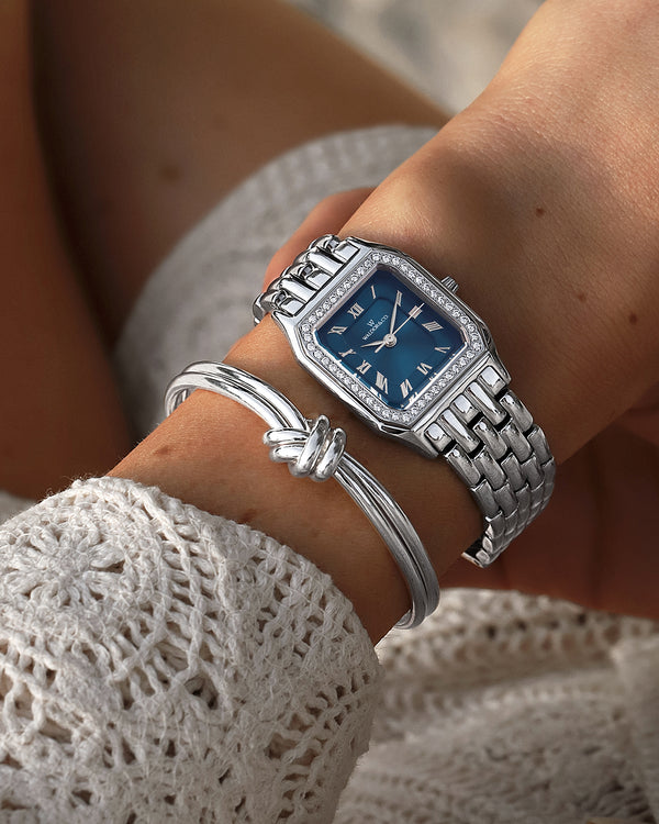A Bangle Bracelet in polished Silver plated-316L stainless steel from Waldor & Co. The model is Dual Knot Bangle Polished.