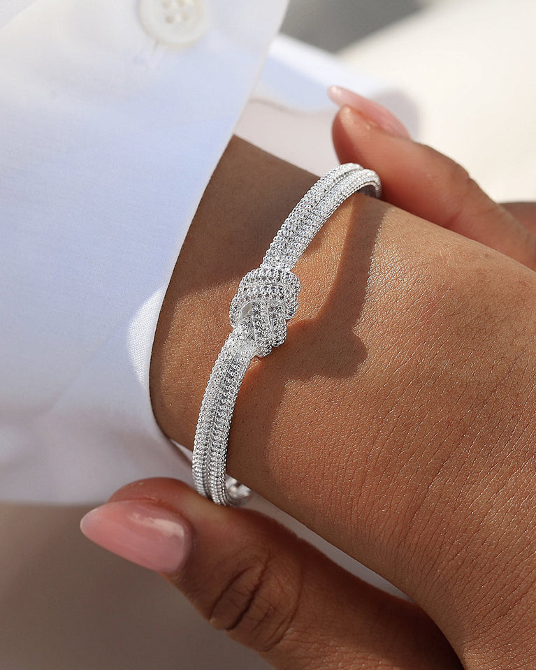 a bange in silver plated copper from Waldor & Co. One size. The model is Dual Knot Bangle Pavè.