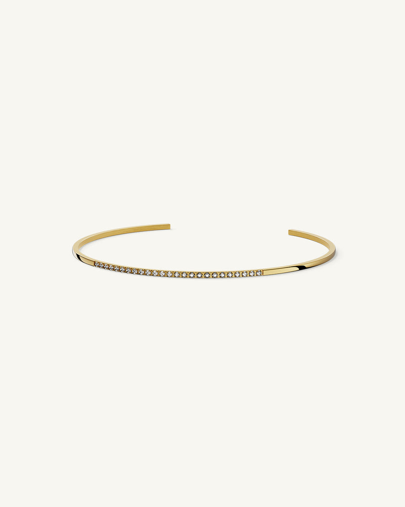 A Bangle in 14k gold-plated 316L stainless steel from Waldor & Co. One size. The model is Bliss Bangle Polished.