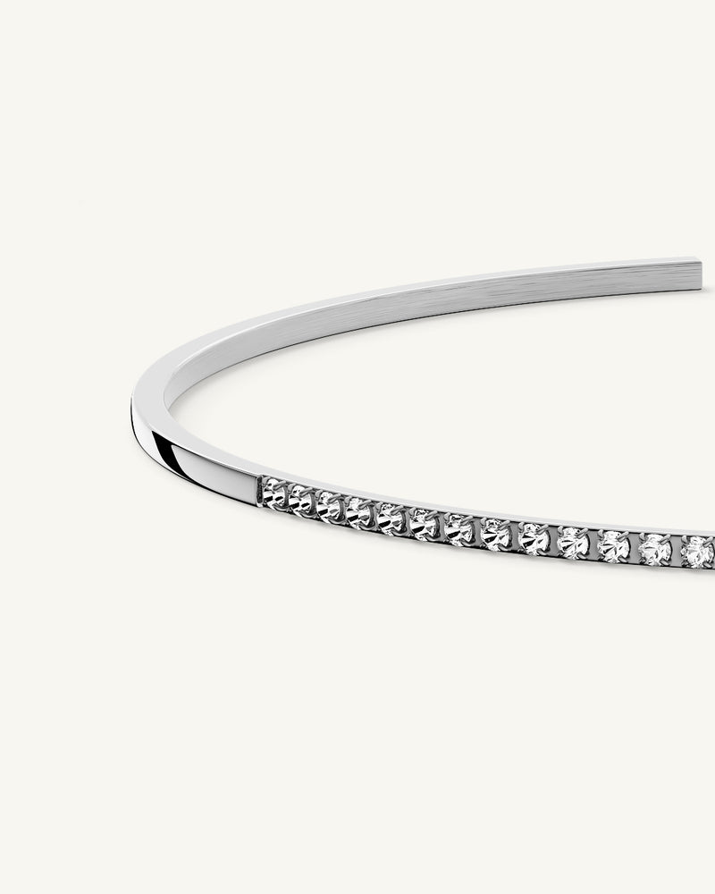 A Bangle in Rhodium-plated 316L stainless steel from Waldor & Co. One size. The model is Bliss Bangle Polished.