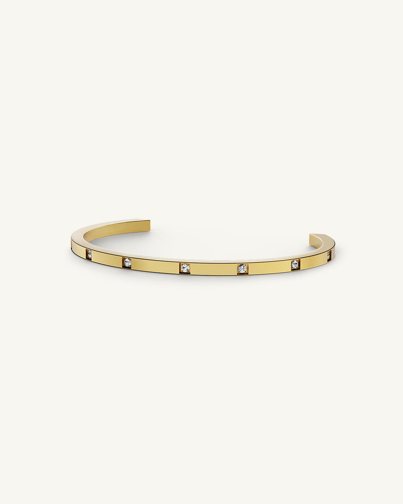 A Bangle Bracelet in 14k gold-plated stainless steel from Waldor & Co. The model is Brilliant Bangle Polished.