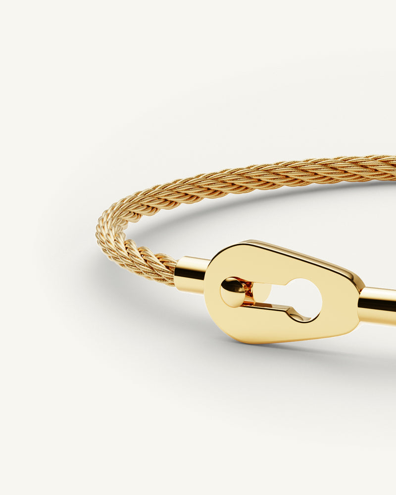 A Bangle in 14k gold 316L stainless steel from Waldor & Co. One size. The model is Como Cable Polished.