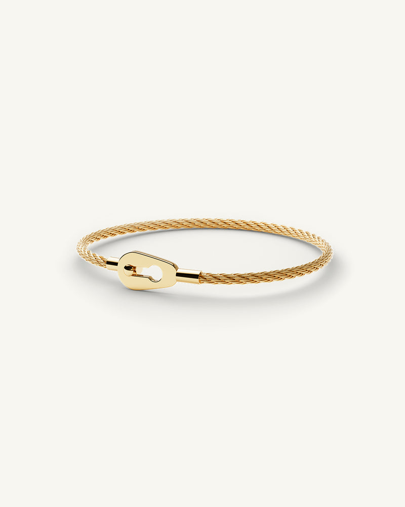 A Bangle in 14k gold 316L stainless steel from Waldor & Co. One size. The model is Como Cable Polished.