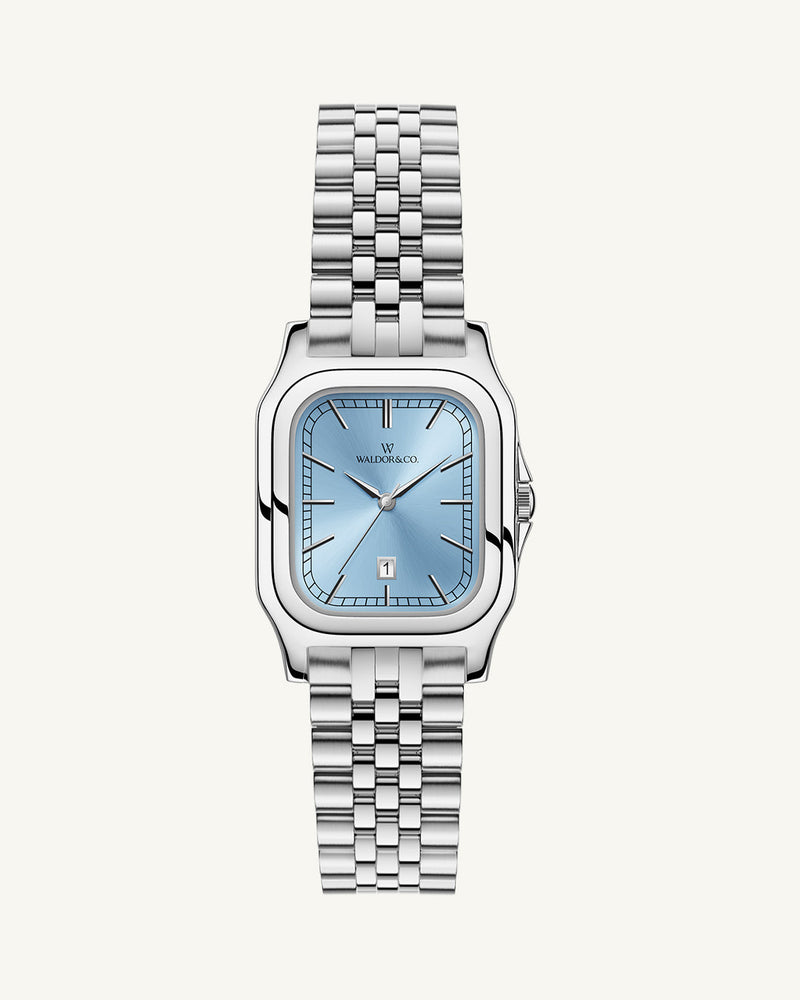 A square womens watch in silver and 14k gold from Waldor & Co. with light blue sunray dial and a second hand. Seiko movement. The model is Delight 32 Chelsea 28x32mm.