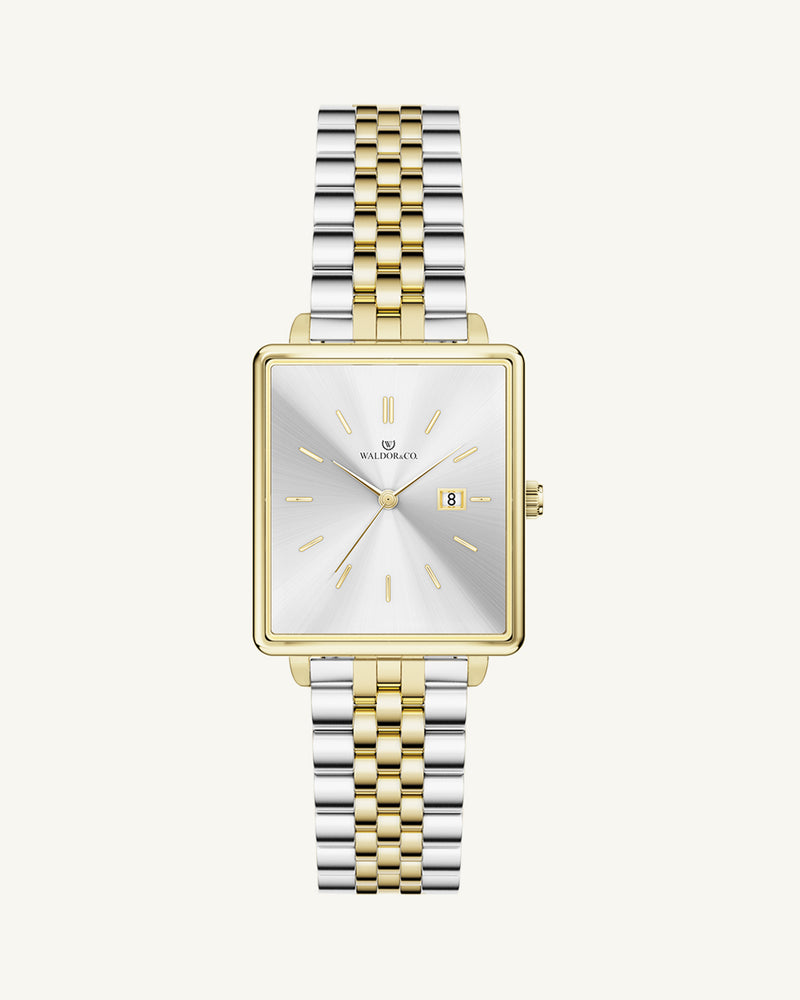 A square womens watch in silver and 14k gold from Waldor & Co. with silver sunray dial and a second hand. Seiko movement. The model is Delight 32 Chelsea 28x32mm.