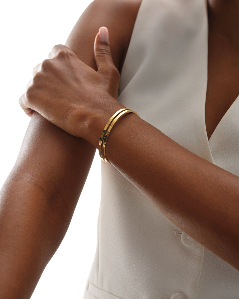 A Bangle in 14k gold plated 316L stainless steel from Waldor & Co. One size. The model is Dual Bangle Polished.