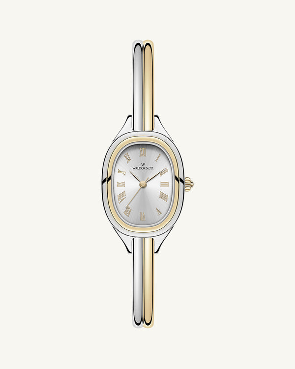 An ellipse shaped womens watch in Rhodium-plated 316L stainless steel from Waldor & Co. with silver sunray dial in brass. Mineral glass with sapphire crystal coating. Seiko movement. The model is Dual Bangle Watch.
