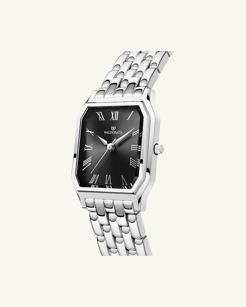 A square womens watch in Rhodium-plated 316L stainless steel from Waldor & Co. with black Diamond Cut Sapphire Crystal glass dial. Seiko movement. The model is Eternal 22 Bellagio.