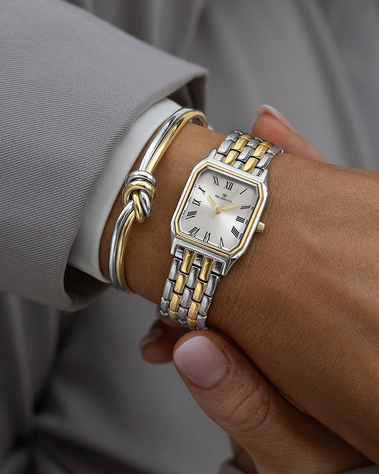 A square womens watch in 22k gold plated 316L stainless steel from Waldor & Co. with white Diamond Cut Sapphire Crystal glass dial. Seiko movement. The model is Eternal 22 Bellagio