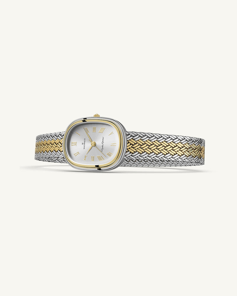 An oval womens watch created under exclusive license from the Greta Garbo™ estate. Featuring a silver sunray dial with gold Roman numerals, framed in a dual-tone case. Seiko movement. 