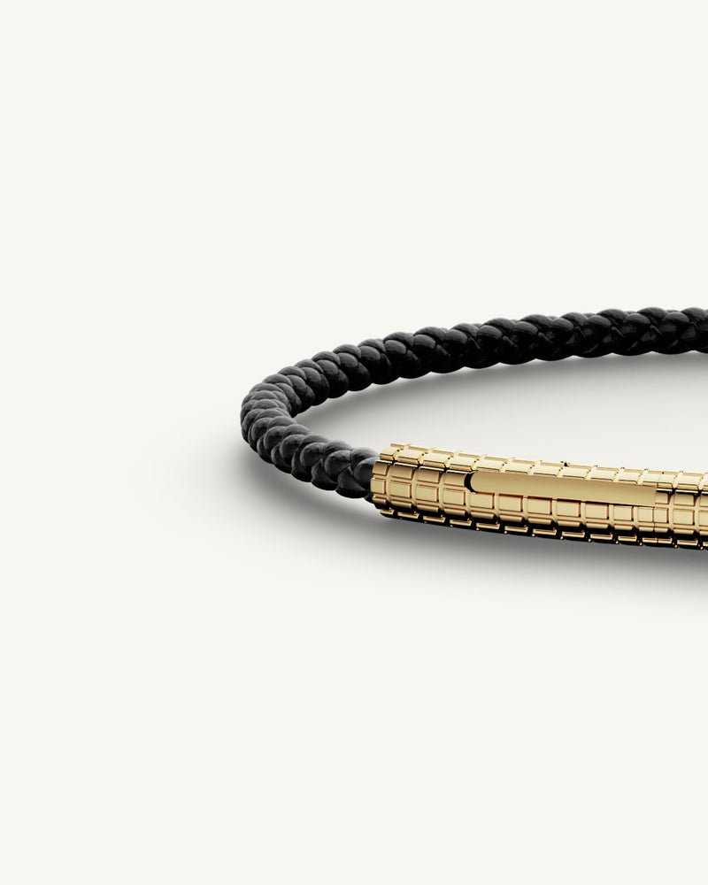 A Leather Bracelet in 14k gold-plated 316L stainless steel from Waldor & Co. The model is Grid Leather Bracelet Polished.