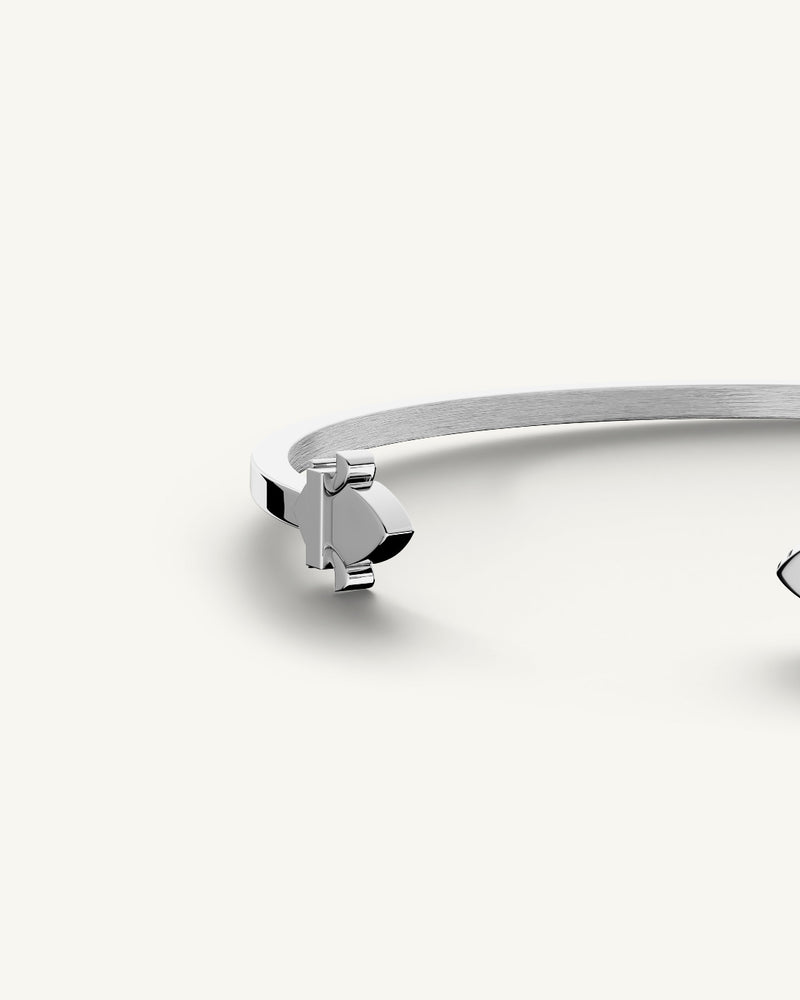 A polished stainless steel bangle in silver from Waldor & Co. One size. The model is Icon Bangle Polished.