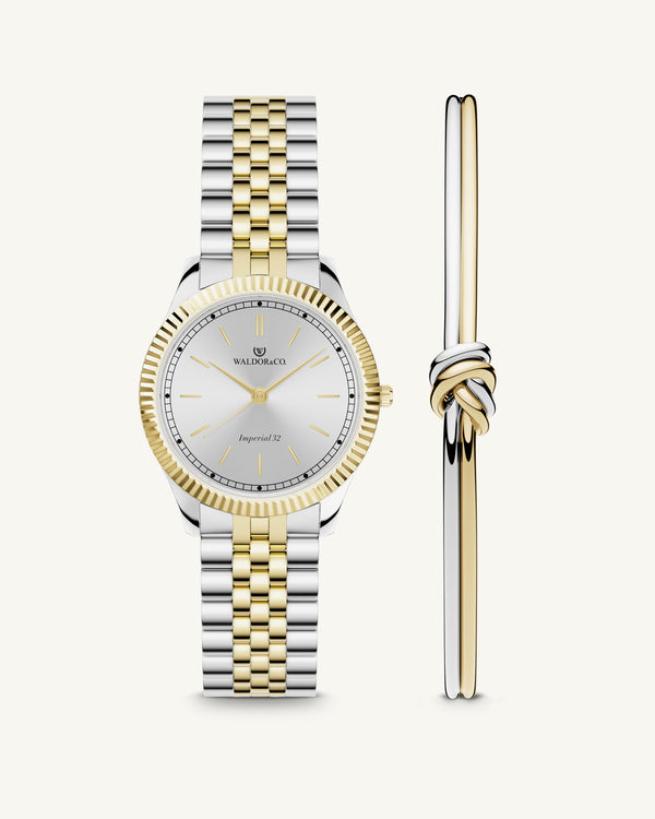 A round womens watch in silver and 22k gold from Waldor & Co. with silver sunray dial and a second hand. Seiko movement. The model is Imperial 32 Positano 32mm.