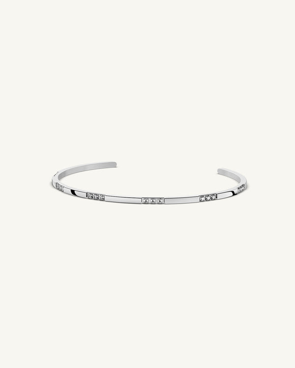 A Bangle in Rhodium-plated 316L stainless steel from Waldor & Co. One size. The model is Opulent Bangle Polished.