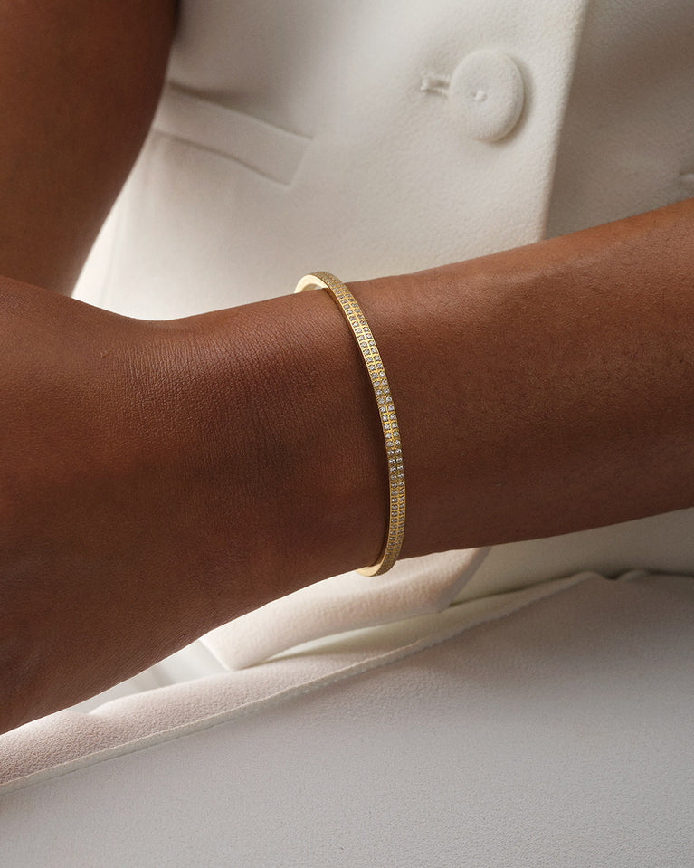 A Bangle in 14k gold plated 316L stainless steel from Waldor & Co. One size. The model is Pavé Bangle Polished.