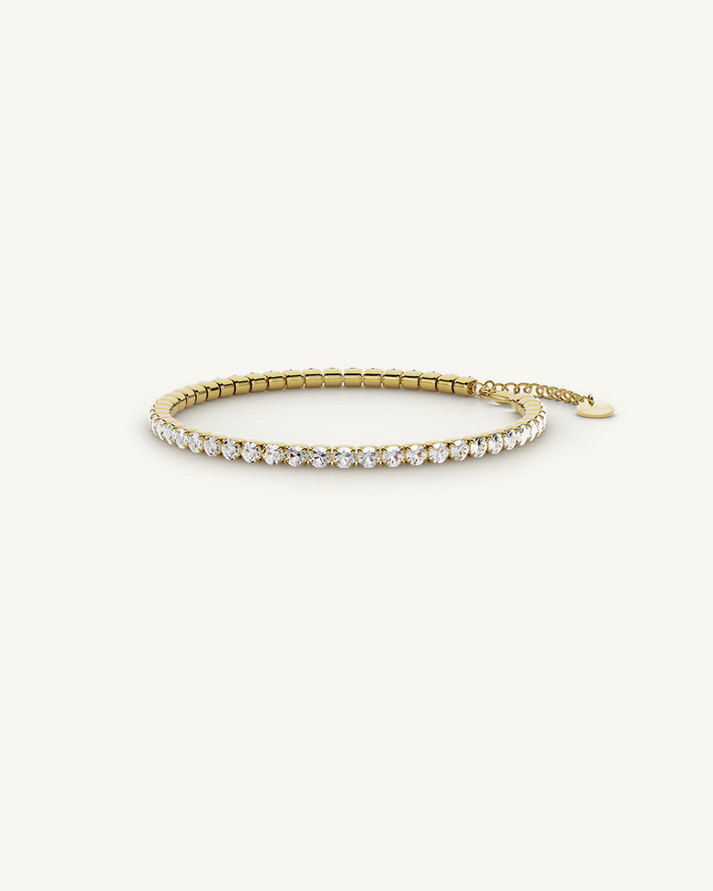 A polished stainless steel chain in 14-k gold plated from Waldor & Co. One size. The model is Tennis Chain Polished